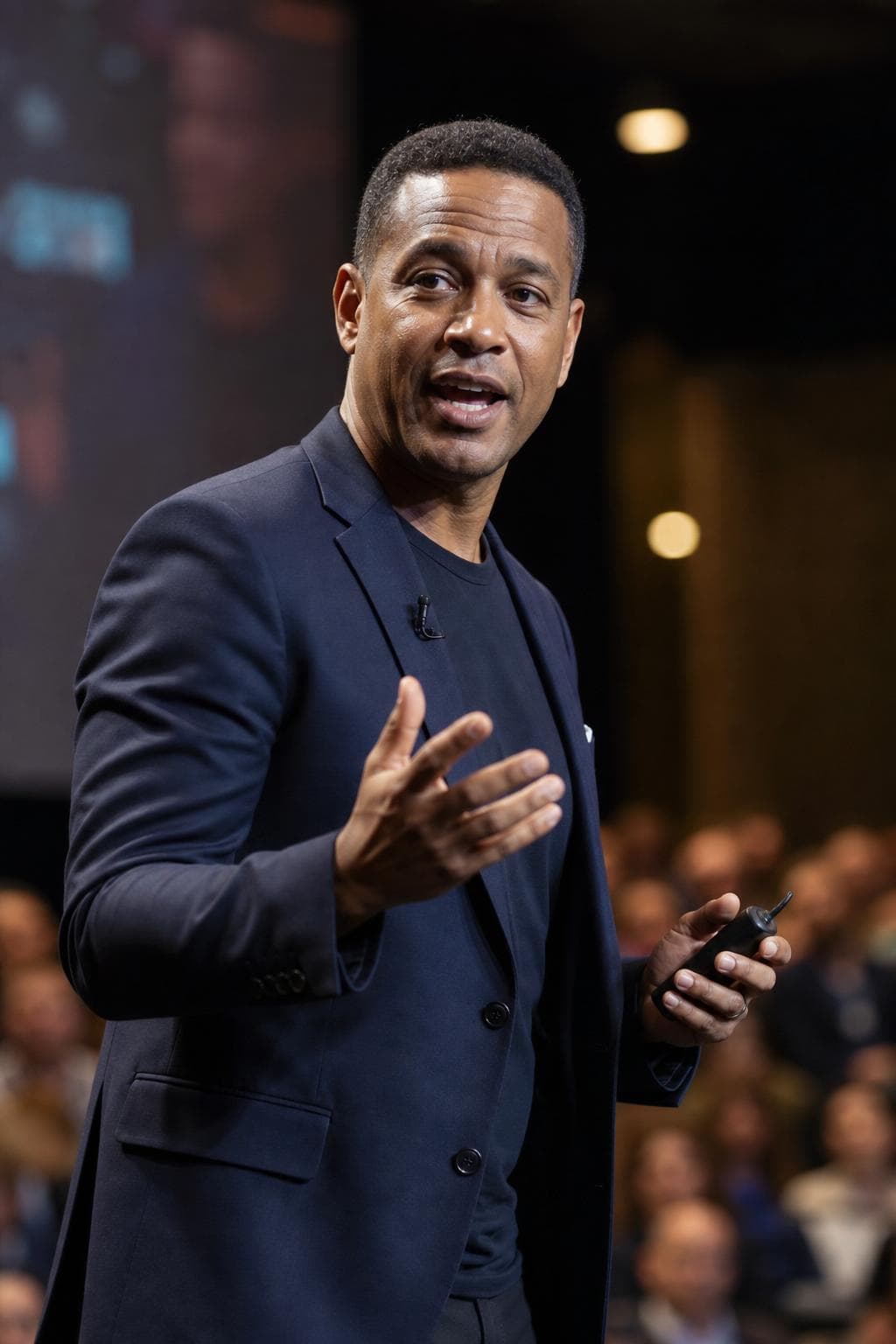 AI headshot in speaker style — man in blazer, warm stage lighting, bokeh audience
